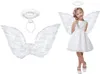 A young girl dressed as an angel, wearing a white dress, wings, and halo, posing for a photo. Beside her are the angel wings and halo set. Anteprima dell’immagine prodotto