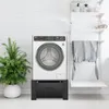 A washing machine stand with a drawer is shown in a laundry room setting. Produktbild-Vorschau