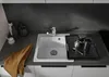 A kitchen sink with a dish drying rack and coffee press. Podgląd zdjęcia produktu