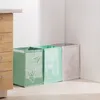 Three recycling bags are placed in a corner next to a wooden cabinet. Produktbild-Vorschau