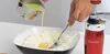 A person is adding liquid ingredients to a bowl of flour with a fork, with a biscuit press visible on the right. Anteprima dell’immagine prodotto