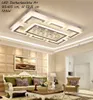 A modern living room with a large LED ceiling light fixture. Produktbild-Vorschau