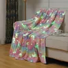 A glow-in-the-dark unicorn blanket draped over a sofa. Náhľad obrázku produktu