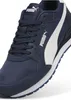 A close-up, studio shot of a single navy blue PUMA sneaker with a white stripe. Produktbild-Vorschau