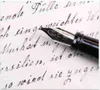 A close-up of a fountain pen nib resting on a handwritten letter. Produktbild-Vorschau