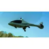 A green drone-like aircraft flying in the sky over a wooded area. Produktbild-Vorschau