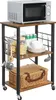 A kitchen cart with a microwave on top and various kitchen items on the shelves. Podgląd zdjęcia produktu