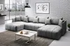 A modern living room with a large sectional sofa, coffee table, and artwork on the wall. Náhled obrázku produktu