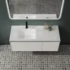 A modern bathroom vanity with a white sink and black faucet, set against a dark green wall and a patterned tile floor. Produktbild-Vorschau