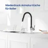 A modern kitchen sink with a black faucet dispensing hot water, creating steam. Produktbild-Vorschau