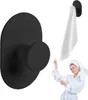 A black towel hook is shown on the left, and a woman in a bathrobe and towel is shown on the right, pointing to a towel hanging on a similar hook. Produktbild-Vorschau