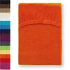 A folded orange fitted sheet is shown against a white background, with a column of other colored fitted sheets to the left. Produktbild-Vorschau