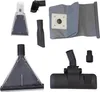 A collection of vacuum cleaner attachments and a dust bag are laid out on a white background. Produktbild-Vorschau