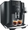 A black Jura E8 coffee machine is shown with two glasses of espresso in front of it. Podgląd zdjęcia produktu