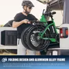 A man is loading a green folding electric bicycle into the trunk of a car. Produktbild-Vorschau