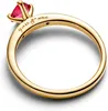 A close-up shot of a gold ring with a red gemstone. Produktbild-Vorschau