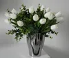 A bouquet of white tulips and greenery in a silver vase. Podgląd zdjęcia produktu