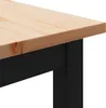A close-up view of the corner of a wooden table with black legs. Anteprima dell’immagine prodotto