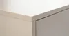 A close-up view of the corner of a beige cabinet with a drawer. Produktbild-Vorschau