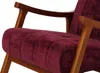 A close-up view of a burgundy armchair with wooden armrests. Anteprima dell’immagine prodotto