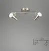 A ceiling light fixture with two adjustable spotlights, shown against a plain gray background. A technical drawing with dimensions is shown in the lower right corner. Produktbild-Vorschau