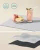 A split image showing a product setup with drinks and fruit on a mat, and a layered view of the product material. Produktbild-Vorschau