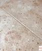 A close-up view of a textured surface, possibly a wall panel or flooring, with a visible seam running diagonally across the image. The surface has a speckled appearance, resembling concrete or marble. Anteprima dell’immagine prodotto
