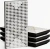 A stack of acoustic panels with a white perforated surface and black foam backing, with one panel standing upright in the foreground. Náhled obrázku produktu