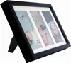 A black multi-photo frame with three vertical photo slots, displayed at an angle on a white background. Náhľad obrázku produktu