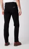 A person wearing black jeans and brown shoes, shown from the back. Produktbild-Vorschau