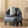 A white cat sits inside a modern, automatic cat litter box in a home setting. Anteprima dell’immagine prodotto