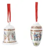 Two Christmas ornaments, a bell and an egg, hanging from red ribbons. Produktbild-Vorschau