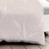 A close-up view of a duvet cover with a subtle leaf pattern. Produktbild-Vorschau