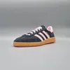 A single Adidas Handball Spezial shoe is shown against a plain gray background. Produktbild-Vorschau