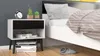 A bedside table next to a bed in a bedroom setting. Anteprima dell’immagine prodotto