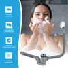 A woman is taking a bath and blowing bubbles, with a bathtub drain assembly shown in the foreground. Produktbild-Vorschau