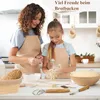A mother and daughter are baking bread in a kitchen, with baking tools and ingredients visible on the counter. Produktbild-Vorschau