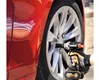 A person is using a cordless impact wrench to remove a lug nut from a car wheel. Podgląd zdjęcia produktu