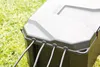 A close-up view of a gray plastic box with cables entering it, resting on grass. Anteprima dell’immagine prodotto