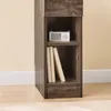 A close-up view of a narrow wooden shelf unit with a small white radio on the top shelf and two books on the bottom shelf. Anteprima dell’immagine prodotto