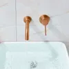A close-up view of a copper wall-mounted faucet with water flowing into a white sink. Anteprima dell’immagine prodotto