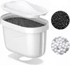A white water filter pitcher with a lid and a filter cartridge containing black granular material and small white spheres. Two circular insets show close-ups of the black granular material and the white spheres. Podgląd zdjęcia produktu