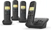 Four black cordless phones are shown on their charging bases, with one phone in the foreground on its base. Produktbild-Vorschau