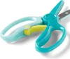 A pair of children's training scissors with teal and light blue handles and a yellow safety lock, shown against a white background. Voir les images du produit