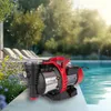 A garden pump is placed on the edge of a swimming pool, surrounded by plants and lounge chairs. Podgląd zdjęcia produktu