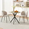 A round dining table with two chairs in a kitchen setting. Produktbild-Vorschau