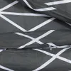 A close-up view of a grey fabric with a white geometric pattern, likely a duvet cover or bedding. Produktbild-Vorschau