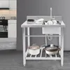 A stainless steel kitchen sink with a faucet and dishes, set against a gray wall. A kitchen scene is visible in the background. Produktbild-Vorschau