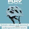 A light blue Puky brand bicycle helmet is shown against a solid light blue background. Text overlays provide marketing information. Anteprima dell’immagine prodotto