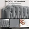 Close-up of a grey upholstered headboard with text overlays highlighting features. Produktbild-Vorschau